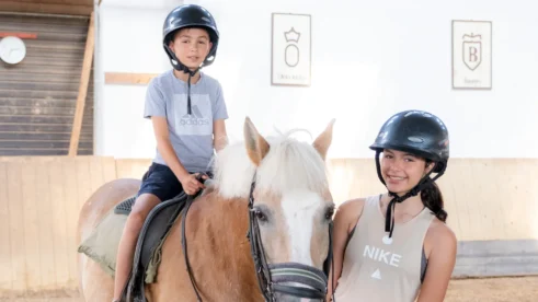 Boy on horseback with girl in front