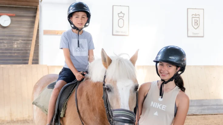 Boy on horseback with girl in front